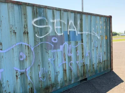 20’ Shipping / Storage Container 8’ wide x 8’ 6” tall, swing doors on one end, wood deck, rings for ...