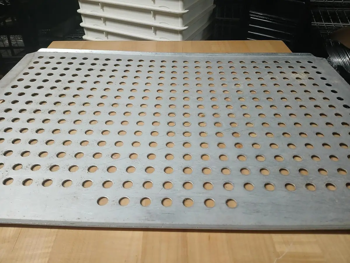 Perforated stainless‑steel baking/cooling sheet