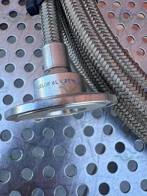 USED FLEXIBLE 200" STAINLESS STEEL BRAIDED HOSE W/ 1"  SANITARY FITTING