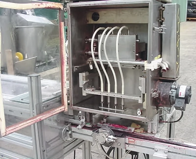 USED FOUR PISTON  HEATED HOT POUR FILLER 4 PISTON HOT POUR