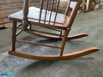 Lot of (2) wooden rocking chairs- brown press back oak rocking chair & black Boston rocker...