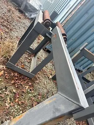 Used Grey Powered Conveyor with load staging on side