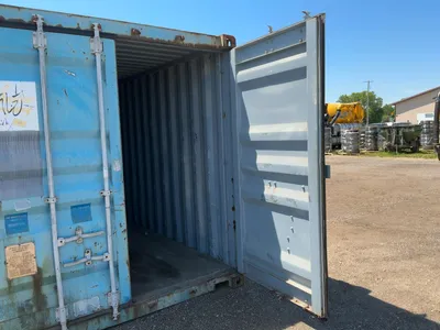 20’ Shipping / Storage Container 8’ wide x 8’ 6” tall, swing doors on one end, wood deck, rings for ...