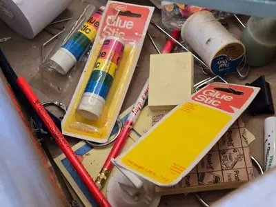 Assorted Office and Craft Supplies including Giant Pencil Decor, Cable Organizer, Glue Stic Foam Cushion Roll, and Miscellaneous Tools
