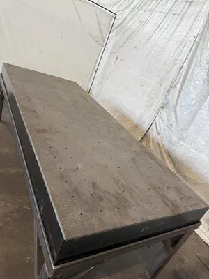 50" X 124" DRILLED & TAPPED STEEL LAYOUT TABLE W/ STAND. STOCK # 0667025.