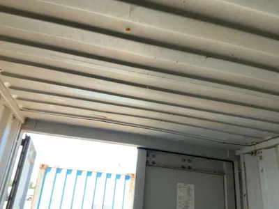 20’ Shipping / Storage Container 8’ wide x 8’ 6” tall, swing doors on one end, wood deck, rings for ...