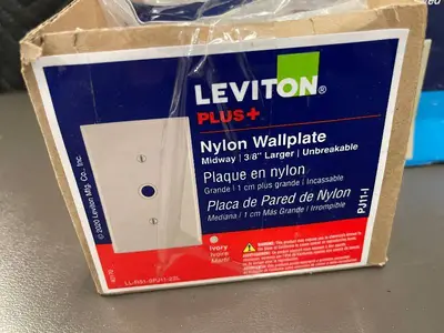 Box of 10 Leviton Ivory Nylon Midway Wallplates and box of Plastic wallplates.