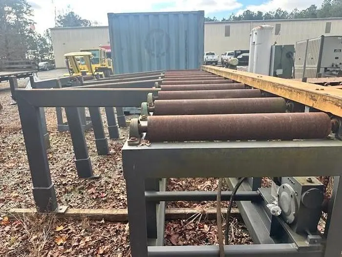 Used Grey Powered Conveyor with load staging on side
