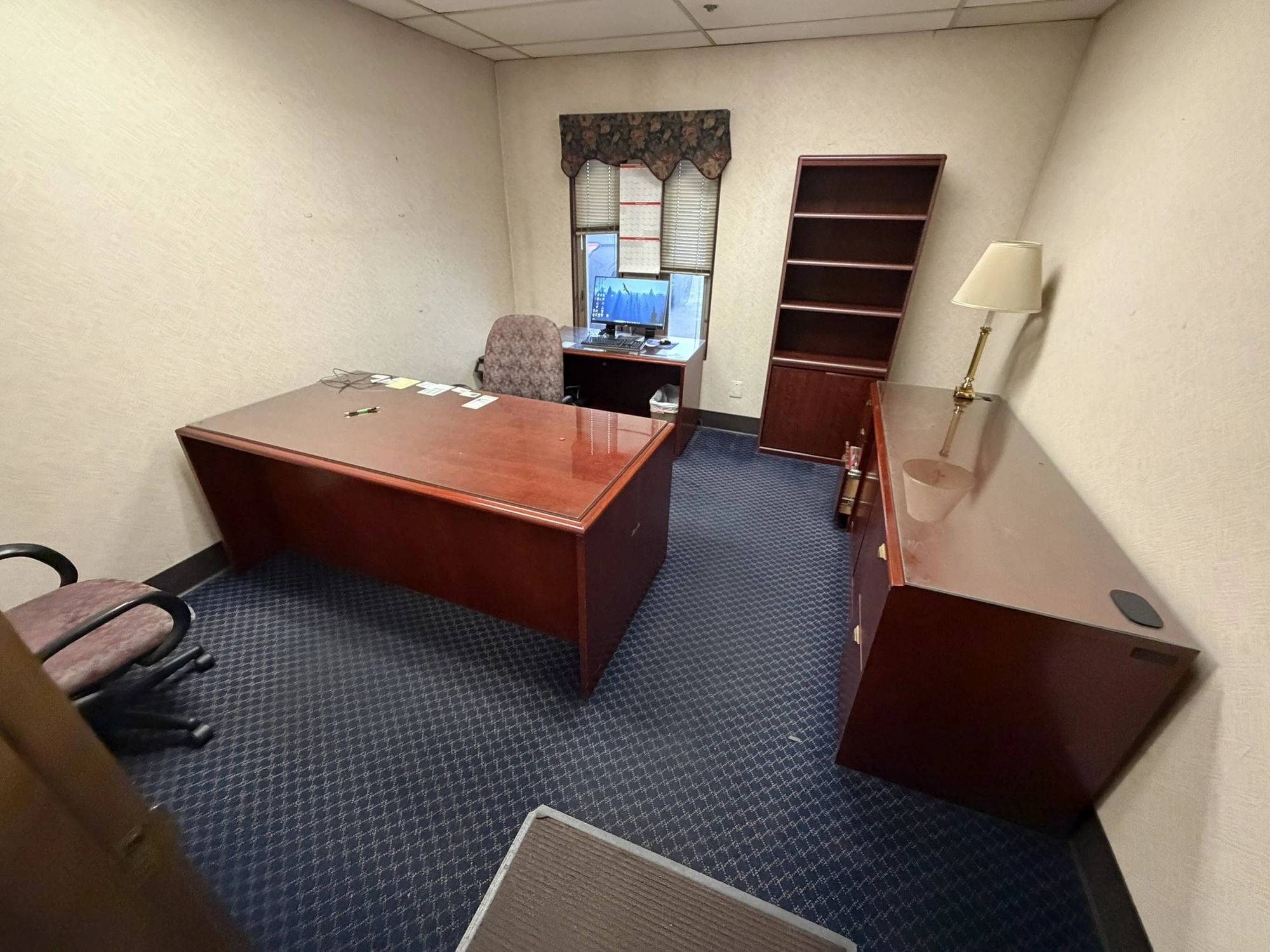 Contents of office furniture, includes (1) wood desk with glass top, 71" x 36", (1) wood credenza wi...