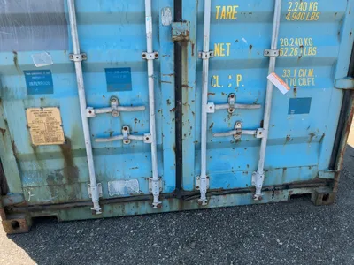 20’ Shipping / Storage Container 8’ wide x 8’ 6” tall, swing doors on one end, wood deck, rings for ...
