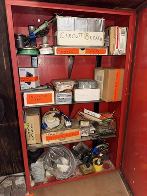 (2) Auto Call single door storage cabinets filled with assorted electrical items, including Push Mat...