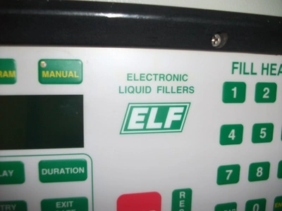 6 Head ELF Filler with feed tanks & container link belt conveyor
