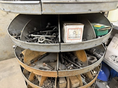 (1) 7-tier lazy Susan style parts rack, approx. 66" tall, includes assorted socket head cap screws, ...