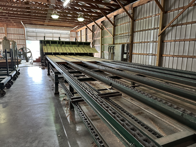 6 strand, 120' green chain with incoming deck and hoist. 24 heavy duty carts
