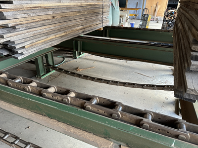 6 strand, 120' green chain with incoming deck and hoist. 24 heavy duty carts