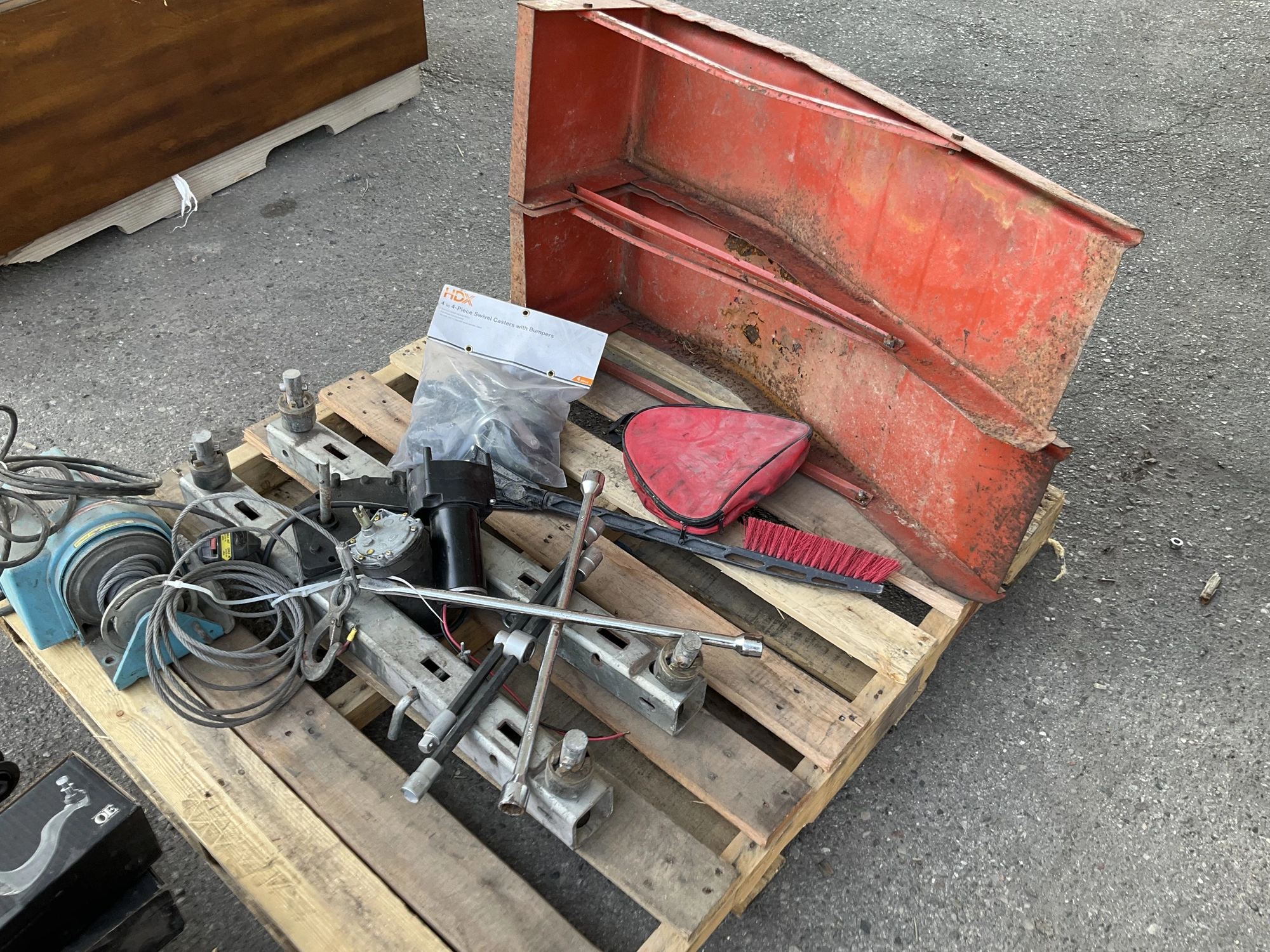 Skid lot of 4 piece swivel casters with bumpers, pulley with cord and remote, a snow scraper, a trac...