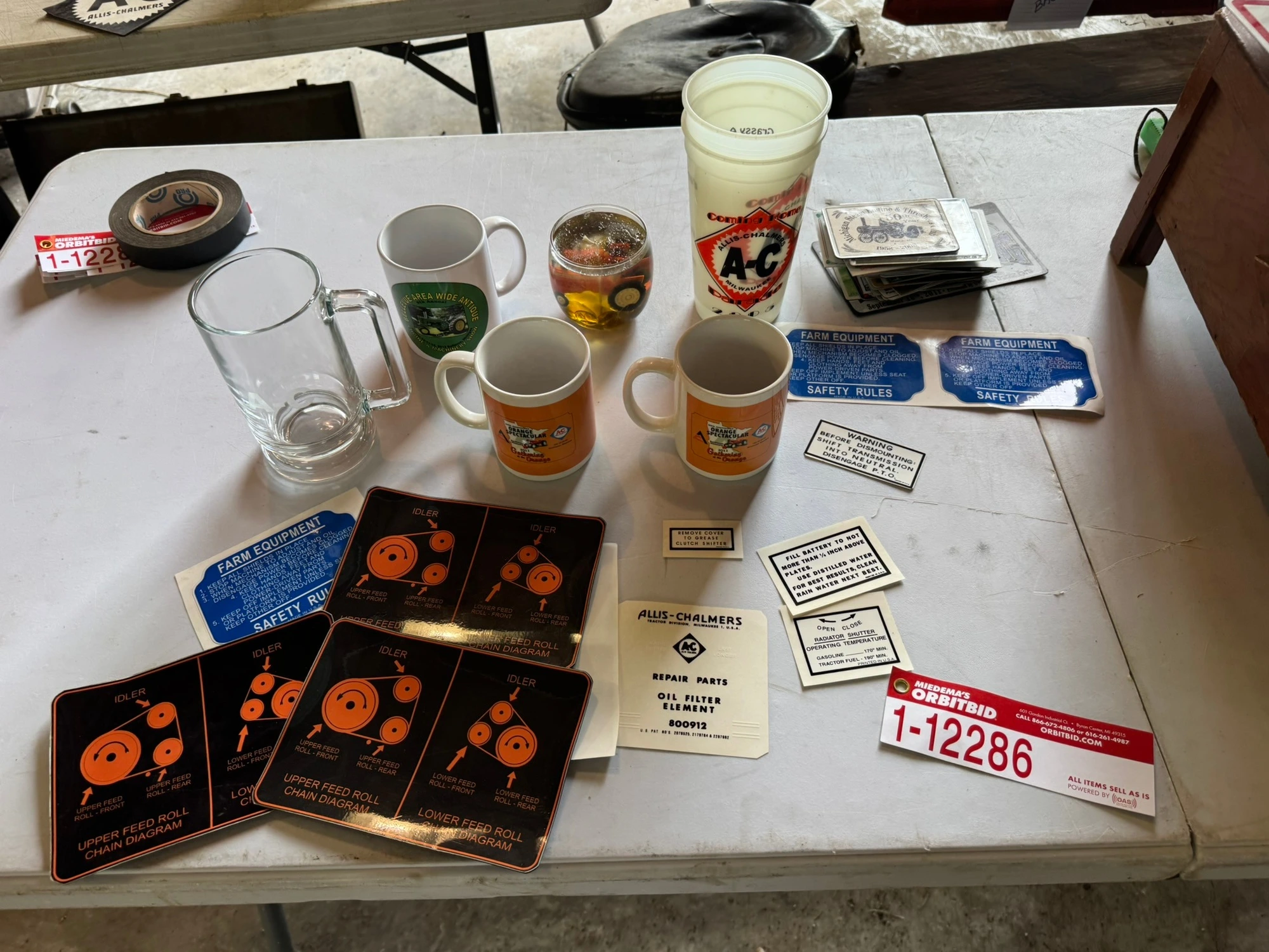 (1) Assorted Allis-Chalmers items including cups, stickers