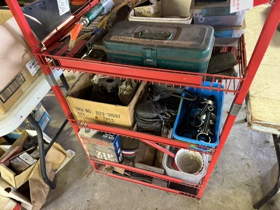 (1) small wire shelf with assorted contents, includes Dremel tool, small battery charger, pneumatic ...