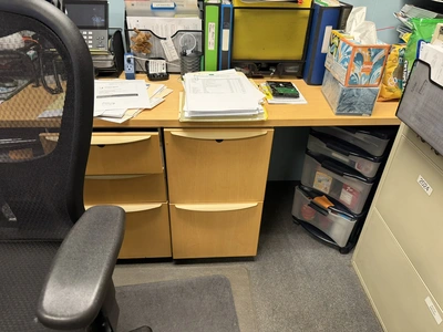 (1) L-shaped wooden desk, approx. 84" x 118" with dual monitor holders, does not include contents, d...
