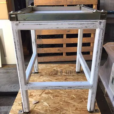 Heavy duty steel frame work tables with adjustable feet.