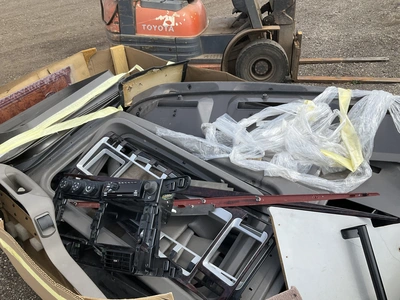 Skid of used semi truck truck interior parts including dash panels, trim, climate control panels, ve...
