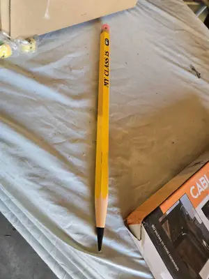 Assorted Office and Craft Supplies including Giant Pencil Decor, Cable Organizer, Glue Stic Foam Cushion Roll, and Miscellaneous Tools