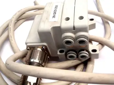 USED SMC 2 VALVE MANIFOLD 4 PORT, W/ (2) 26 PIN CABLE