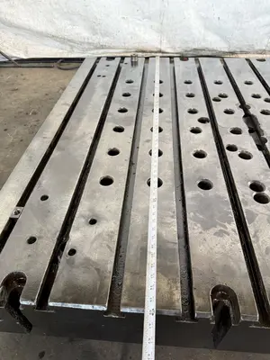 60" WIDE X 67" LONG X 9" THICK T-SLOTTED BOLSTER PLATE. STOCK # 1006324