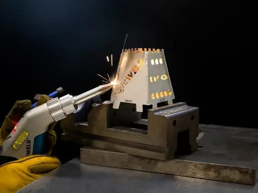 IPG LightWELD handheld laser welding system producing sparks on stainless steel