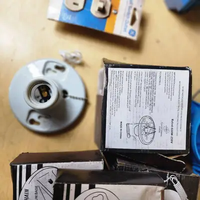 Lot of Electrical Supplies Including Porcelain Pull Chain Lampholders, GE Wall Switch Outlet, and Electrical Boxes