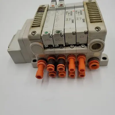 USED SMC SMC FOUR SOLENOID AIR CONTROL VALVES VQ2000-10A-1 MOUNTED ON MANIFOLD VV5QC41