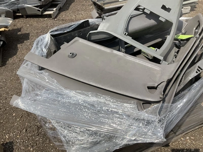Skid of Kenworth interior parts including dash panels and sleeper cab components, used