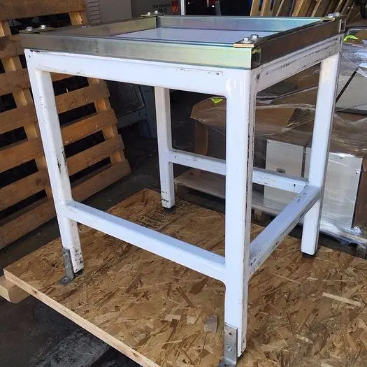 Heavy duty steel frame work tables with adjustable feet.