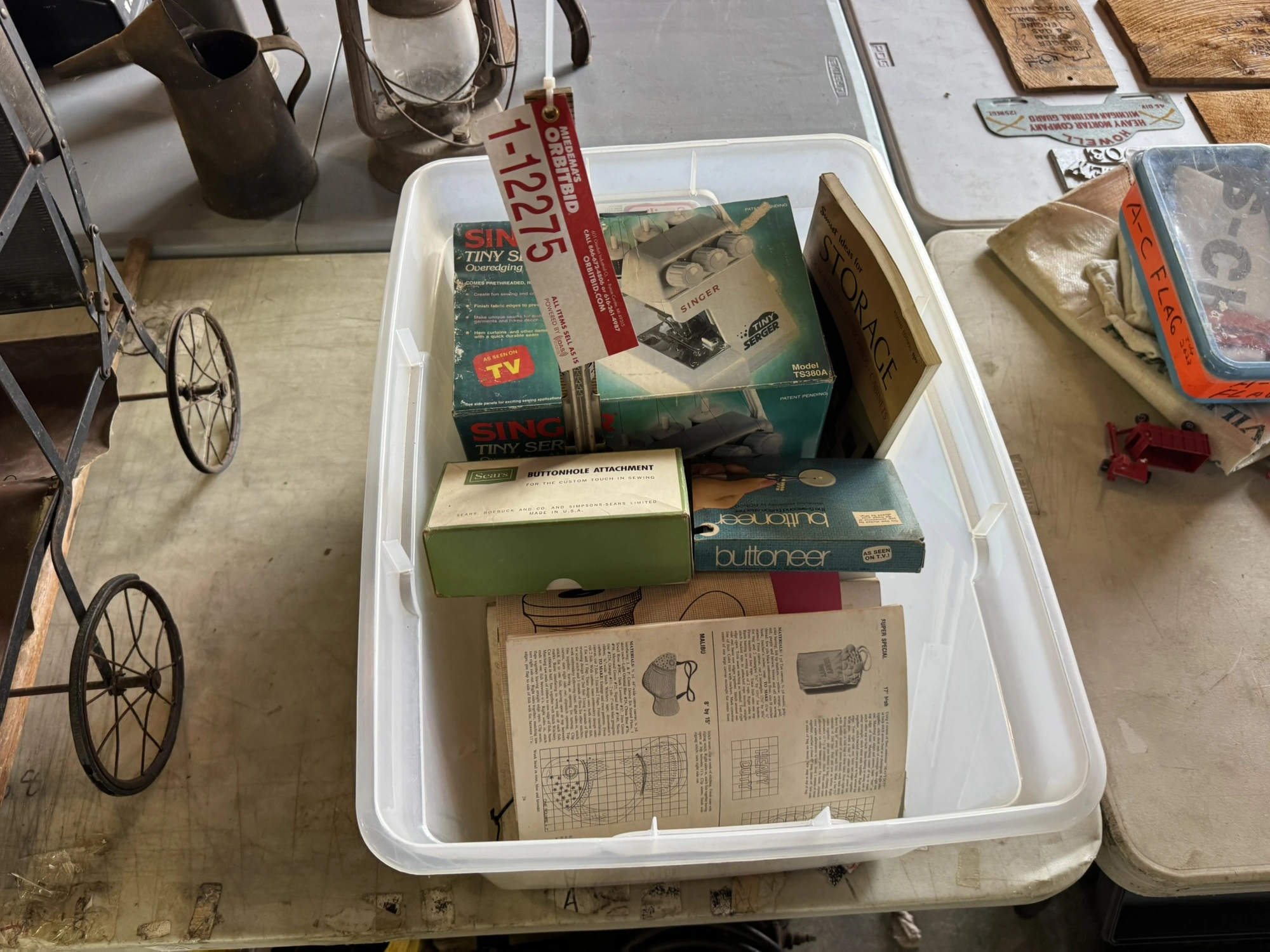 (1) Singer Tiny over edging machine, assorted patterns, and sewing items.