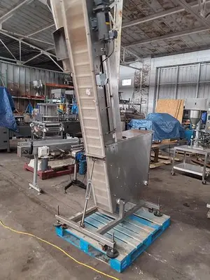 Inline Filling Systems capper with Waterfall feeder