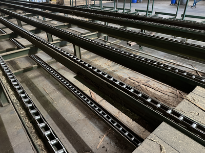 6 strand, 120' green chain with incoming deck and hoist. 24 heavy duty carts