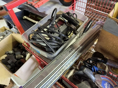 (1) small wire shelf with assorted contents, includes Dremel tool, small battery charger, pneumatic ...