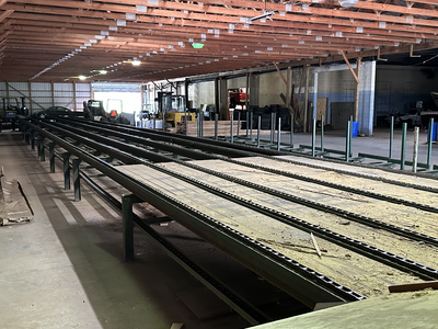 6 strand, 120' green chain with incoming deck and hoist. 24 heavy duty carts
