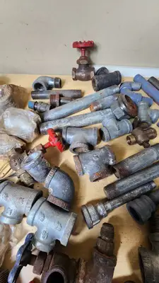 Lot of Plumbing Hardware and Fittings including Galvanized Nipples, Elbows, Valves, and Connectors
