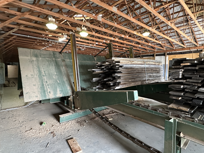 6 strand, 120' green chain with incoming deck and hoist. 24 heavy duty carts