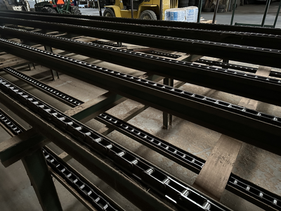 6 strand, 120' green chain with incoming deck and hoist. 24 heavy duty carts