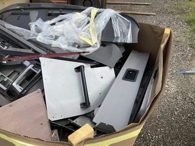 Skid of used semi truck truck interior parts including dash panels, trim, climate control panels, ve...