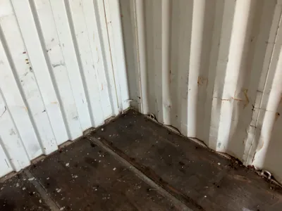 20’ Shipping / Storage Container 8’ wide x 8’ 6” tall, swing doors on one end, wood deck, rings for ...