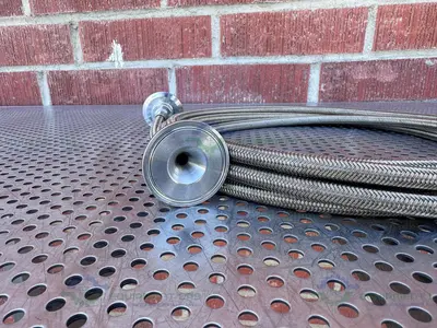USED FLEXIBLE 200" STAINLESS STEEL BRAIDED HOSE W/ 1"  SANITARY FITTING