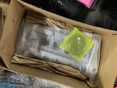 Lot of various car parts including Tesla storage bins, a sunroof deflector, mud flaps, a Colorado...