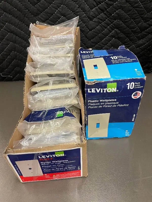Box of 10 Leviton Ivory Nylon Midway Wallplates and box of Plastic wallplates.