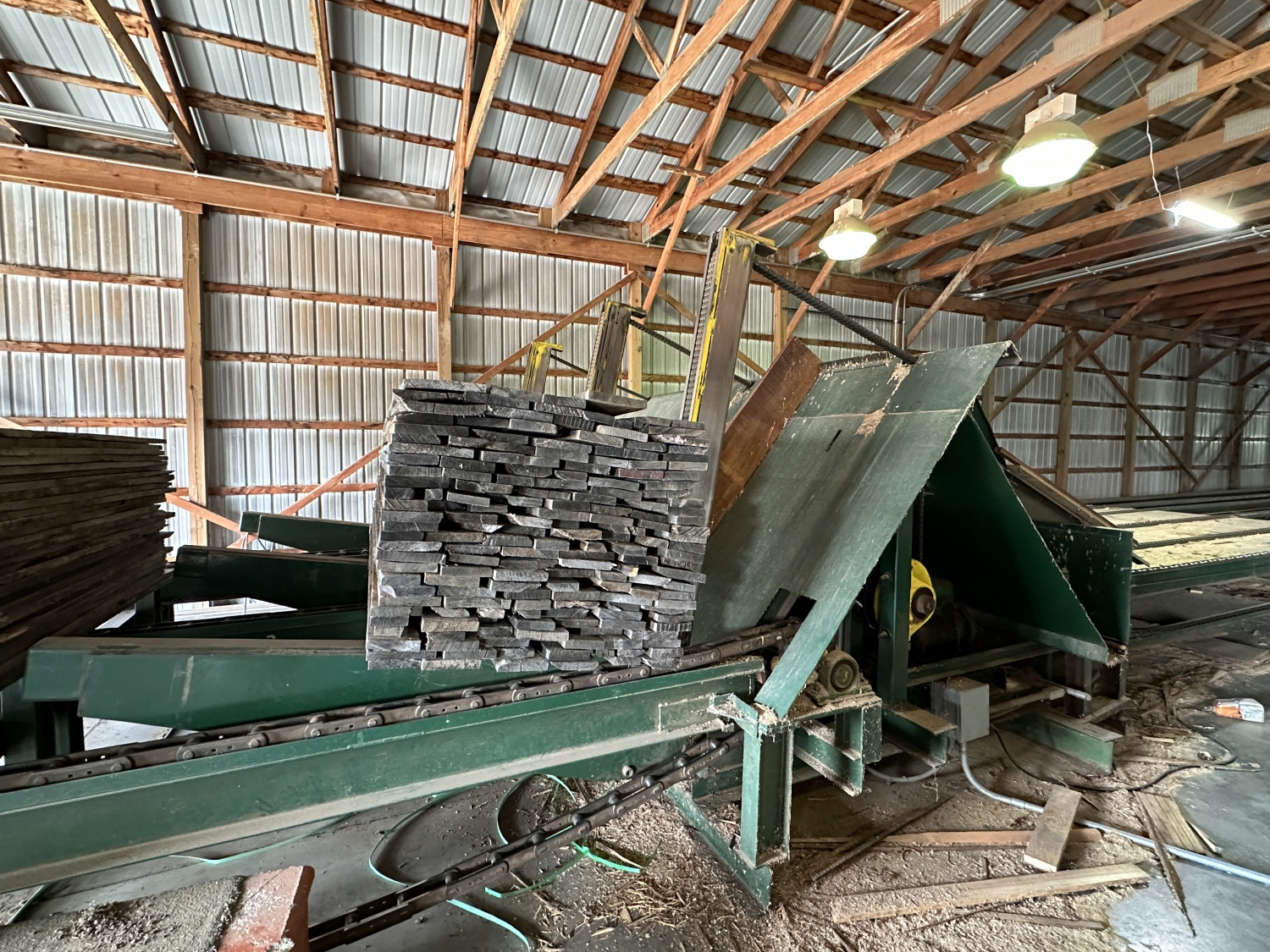 6 strand, 120' green chain with incoming deck and hoist. 24 heavy duty carts