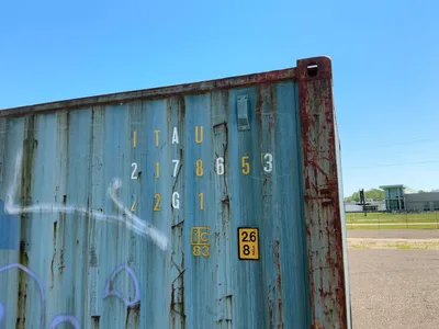 20’ Shipping / Storage Container 8’ wide x 8’ 6” tall, swing doors on one end, wood deck, rings for ...
