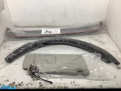 Lot of various car parts including Tesla storage bins, a sunroof deflector, mud flaps, a Colorado...
