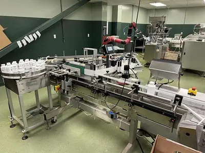 Quadrel model Q110 pressure sensitive wraparound labeler